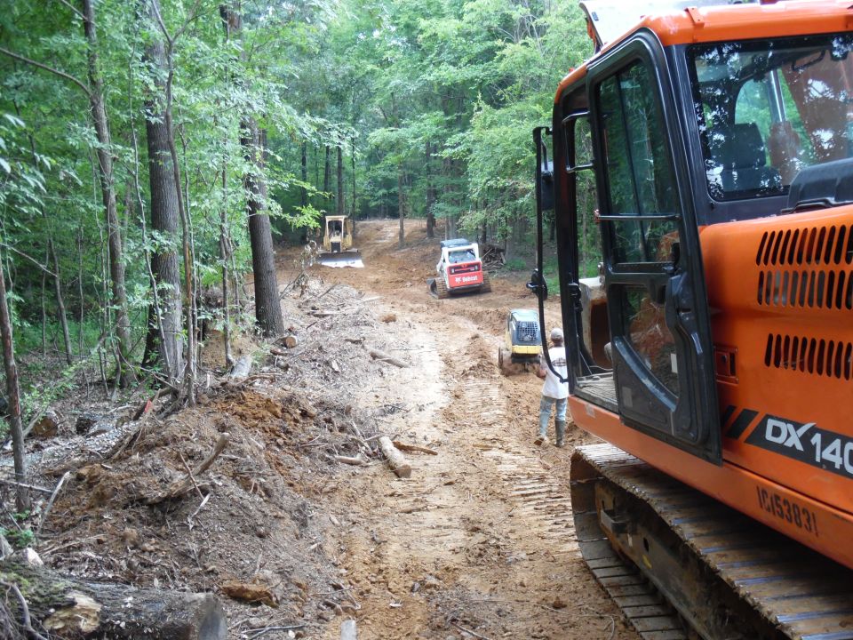 When the electrician & gas company left July 1, the trench was packed by a radio-controlled roller, and then grading began.