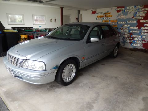 1999 Ford Fairlane - A silver sedan is parked indoors, showing its front and side profile.