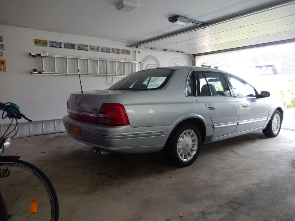 Silver sedan parked in garage, rear view