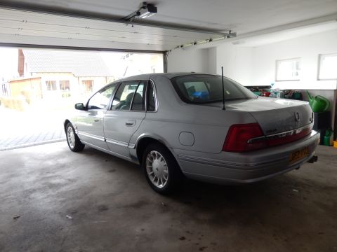 1999 Ford Fairlane - Rear view of a 1999 Ford Fairlane sedan parked inside a garage.