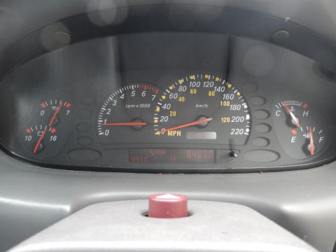 1999 Ford Fairlane - The vehicle's interior shows the dashboard gauges, including the speedometer and odometer.