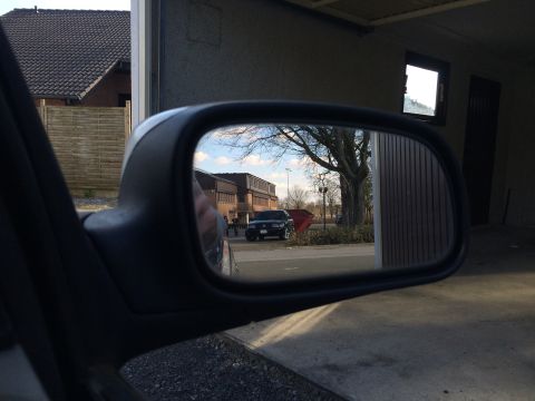 1999 Ford Fairlane - Reflection in the side mirror shows a dark SUV parked outside a building.
