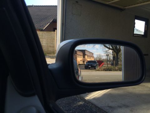 1999 Ford Fairlane - A black SUV is visible in the side mirror of a car parked in a garage.
