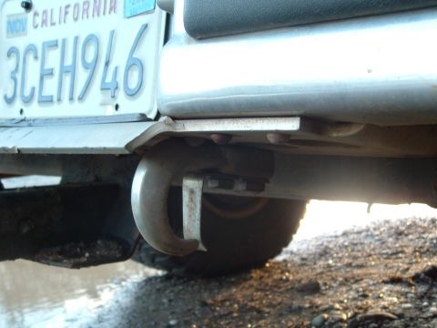 1990 Ford Bronco - Close-up of a rear tow hook and a California license plate on a vehicle.