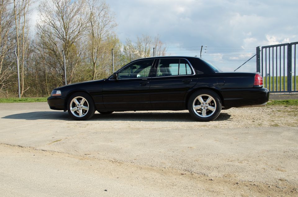 Black 2003 Mercury Marauder sedan parked on dirt lot, side view