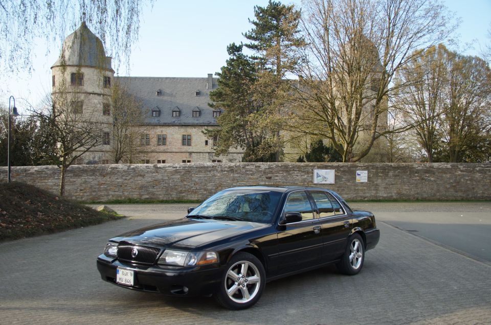2003 Mercury Marauder sedan parked outdoors with a castle-like building in the background