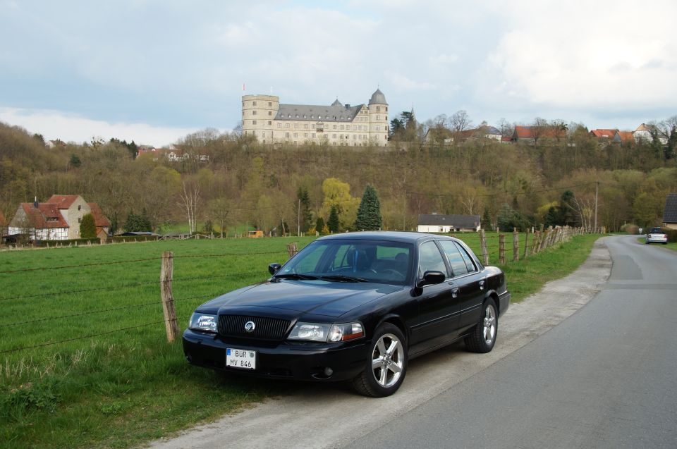 2003 Mercury Marauder parked on the side of a road with a castle in the background