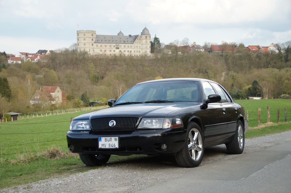 2003 Mercury Marauder parked on gravel road with a castle in the background
