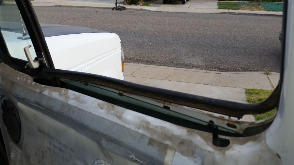1992 Ford Bronco window frame with trim removed, showing interior door panel