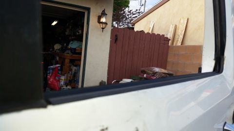 1992 Ford Bronco - View from inside a white vehicle shows a garage and a wooden fence.