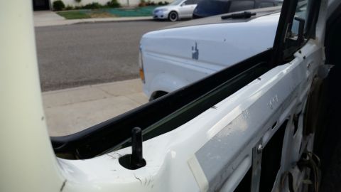 1992 Ford Bronco - Door frame of a 1992 Ford Bronco, with another Bronco visible behind it.