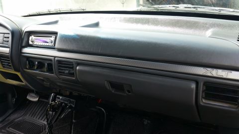 1992 Ford Bronco - Interior view of a 1992 Ford Bronco, the dashboard with XLT badging and an aftermarket stereo system.