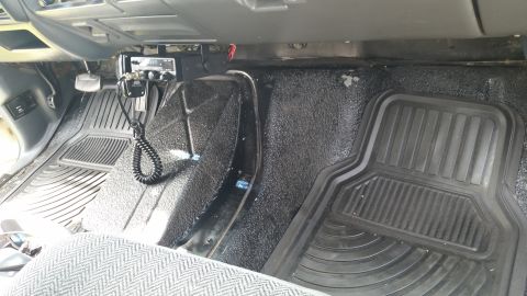 1992 Ford Bronco - Vehicle interior features floor mats, pedals, and an aftermarket CB radio installation.