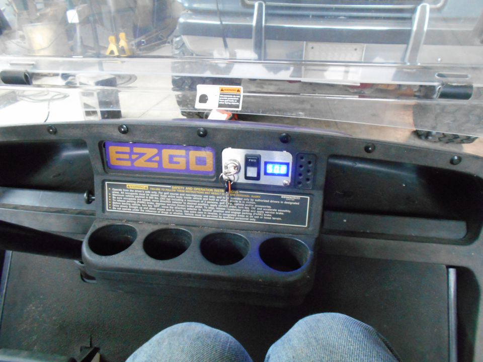 Golf cart dashboard with EZGO logo and digital display
