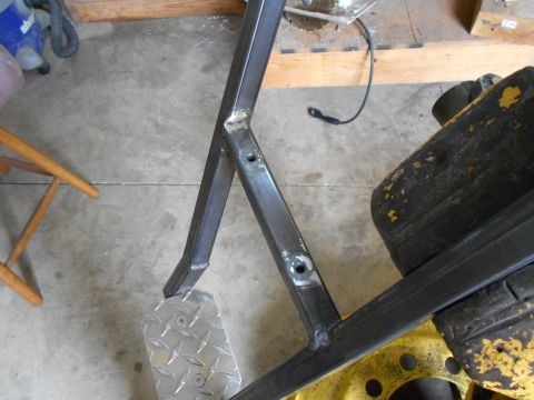 1992 Ford Bronco - A close-up view of a metal frame with a diamond plate step, likely a component of larger machinery.