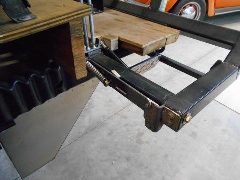 1992 Ford Bronco - Close-up of a trailer hitch mechanism, with an orange vehicle visible in the background.