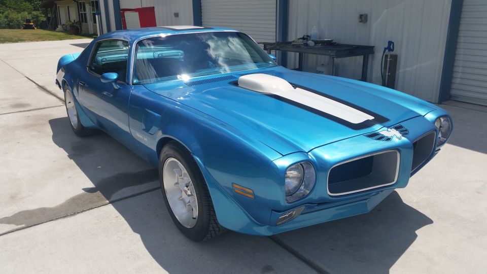 Blue 1970 Pontiac Trans Am with white racing stripes on hood