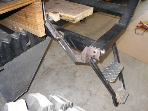 1992 Ford Bronco - Detail of a trailer hitch assembly, metal steps and wooden bracing.
