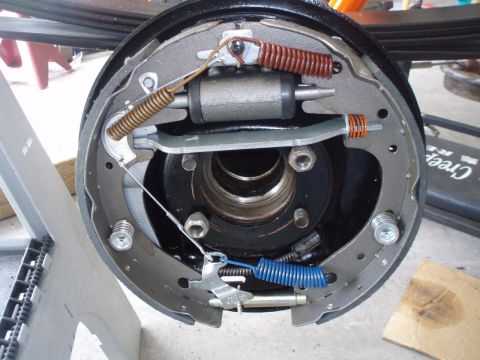 1972 Ford Bronco - This is a close-up view of the internal workings of a drum brake assembly, likely from a 1972 Ford Bronco. The image shows brake shoes, spr…