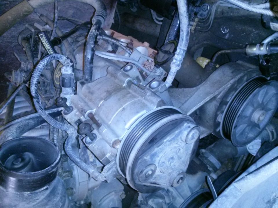 1996 Ford Bronco engine bay with air intake and AC compressor visible.