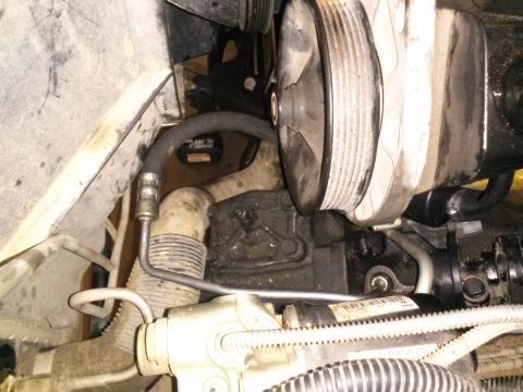 1996 Ford Bronco - This is a close-up view of the power steering pump and associated hoses in a 1996 Ford Bronco. The pump pulley and a portion of the pump ho…