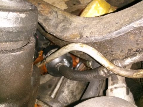 1996 Ford Bronco - A close-up view of various automotive hoses and metal lines, likely from the engine bay or undercarriage of a vehicle. The components are g…