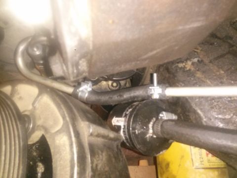 1996 Ford Bronco - A close-up view shows a black hose secured with hose clamps to a metal component. Another metal tube is visible above the hose, also attach…