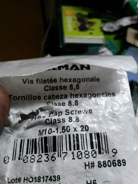 1996 Ford Bronco - A close-up shot of a plastic bag containing metric M10-1.50 x 20 Class 8.8 Hex Cap Screws. The bag has text in French, Spanish, and English…