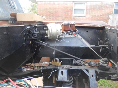 1972 Ford Bronco - The engine bay of a classic Ford Bronco undergoing restoration, showing the brake booster, master cylinder, and various engine components.…