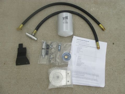 2007 Ford F-250 - A coolant filter kit is laid out with hoses and a document.