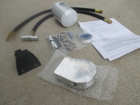 2007 Ford F-250 - Parts laid out for a coolant filter installation kit, including a Wix filter and various fittings.
