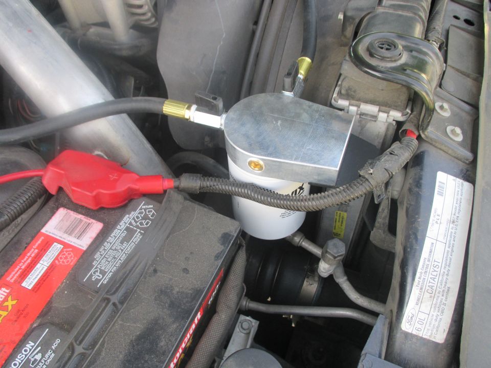 Coolant filter assembly with hoses and battery