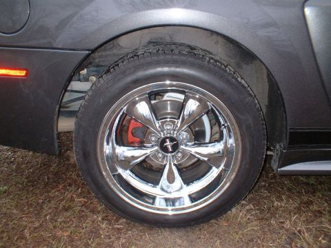 2003 Ford Mustang - Close-up of a 2003 Ford Mustang's chrome wheel and part of the fender.