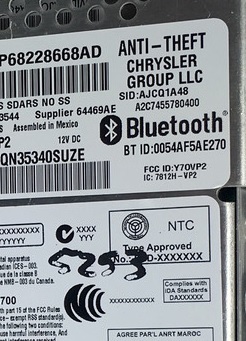 2000 Ford Crown Victoria - Close-up of a Chrysler Group LLC Bluetooth module, part number P68228668AD, with various identification codes visible.