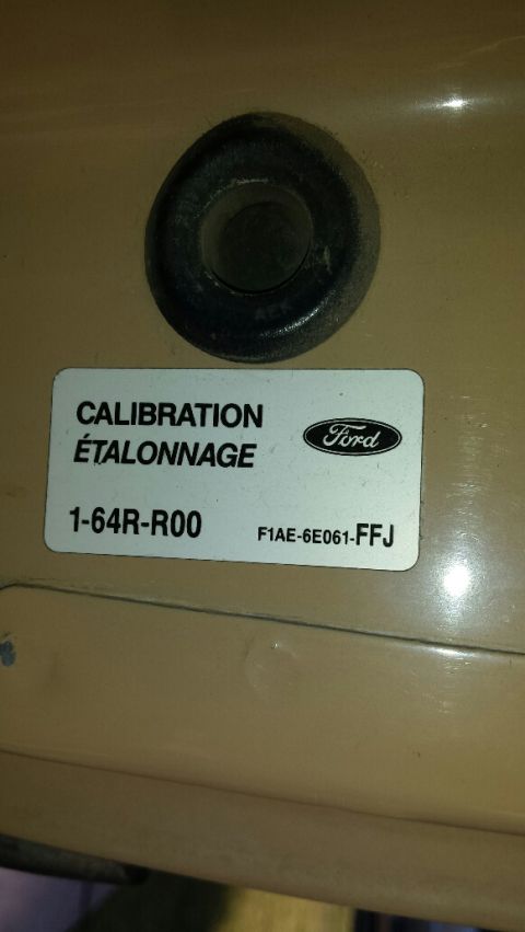 1991 Ford Bronco - A Ford calibration sticker with part numbers is visible on a tan surface.