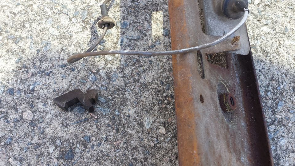 Rusty metal bracket with wire and clip on concrete