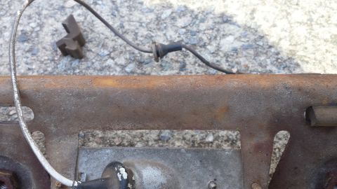 1976 Ford Ranchero - Close view of a rusty metal component with electrical wiring attached.