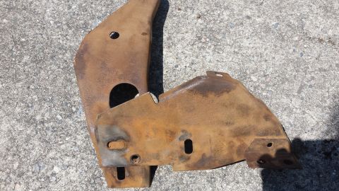 1976 Ford Ranchero - Rusted metal brackets, possibly for a vehicle's rear bumper mounting.