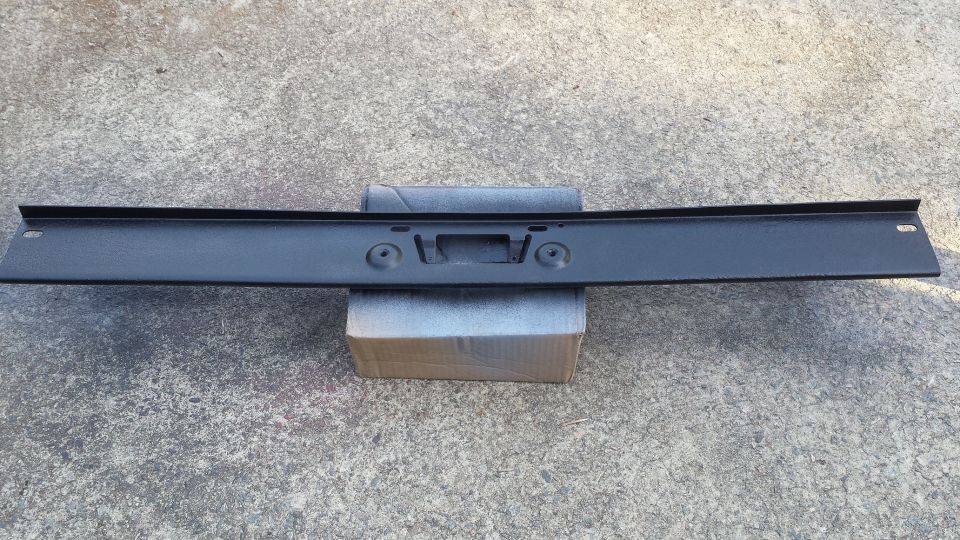 Black rear bumper part with license plate mounting holes