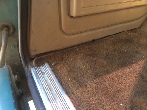 1990 Ford Bronco - Interior view of a vehicle's door sill and carpeted floor.