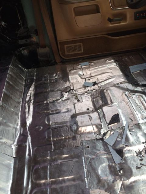 1990 Ford Bronco - Sound deadening material is being applied to the interior floor of a 1990 Ford Bronco.