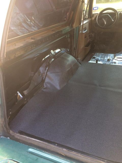 1990 Ford Bronco - The interior of the vehicle shows new carpeting installed in the rear cargo area and floor.