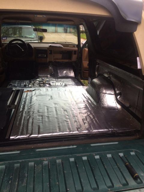 1990 Ford Bronco - The interior of a 1990 Ford Bronco is shown with sound deadening material applied to the floor and cargo area.