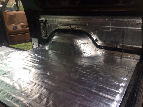 1990 Ford Bronco - Sound deadening material covers the floor and rear wheel wells of a 1990 Ford Bronco's interior.