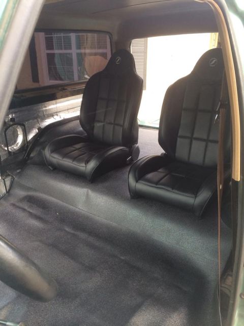 1990 Ford Bronco - Aftermarket bucket seats with a quilted pattern and 'Z' logo are installed in a vehicle's interior.
