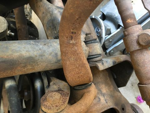 1987 Ford Bronco - This image shows heavily rusted suspension components, likely from an older vehicle undergoing repair.