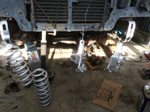 1987 Ford Bronco - Vehicle front suspension parts and springs are laid out for a rebuild project.