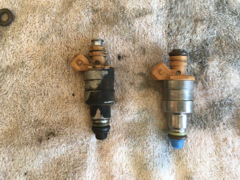 1987 Ford Bronco - A comparison of a dirty fuel injector next to a clean one, likely before or after a cleaning service.