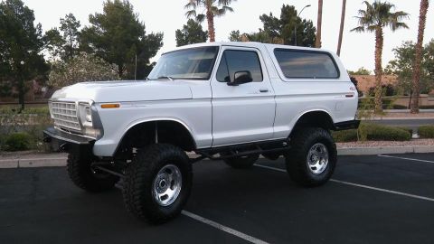 1979 Ford Bronco - This lifted Ford Bronco is shown from a three-quarter front view, highlighting its off-road tires and suspension.