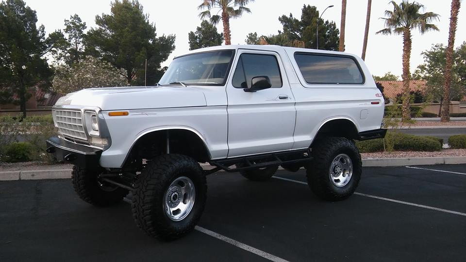 White lifted Ford Bronco parked in a lot